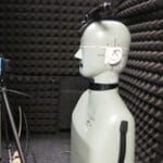 Audio testing and research being done in a WhisperRoom with a dummy and other equipment