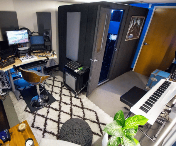 Home studio with a whisperroom recording booth, various recording gear, and instruments.