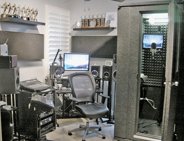 A home studio that is full of studio gear, trophies and a portable vocal booth by WhisperRoom™