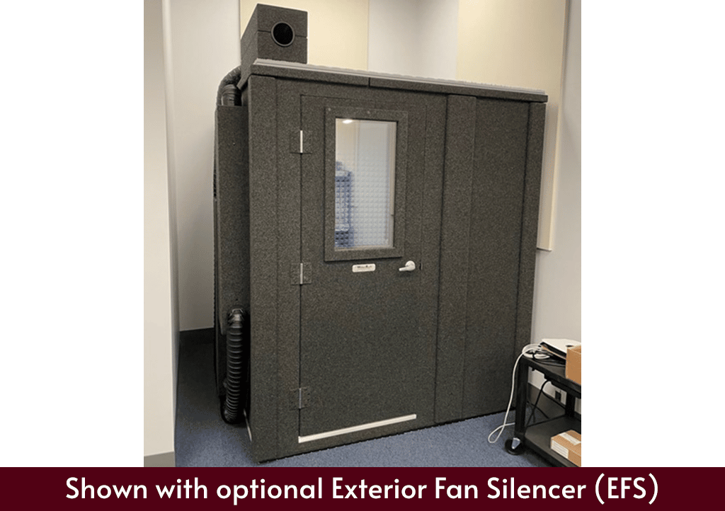 A WhisperRoom sound booth MDL 7272 shown inside of a room with the Exterior Fan Silencer placed on top of the booth.
