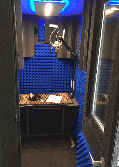image of the inside of a whisperroom booth equipped with a desk, lamp, and blue foam