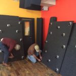 Two men building a WhisperRoom inside of Syracuse Coworks