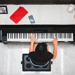 woman playing piano inside of a room