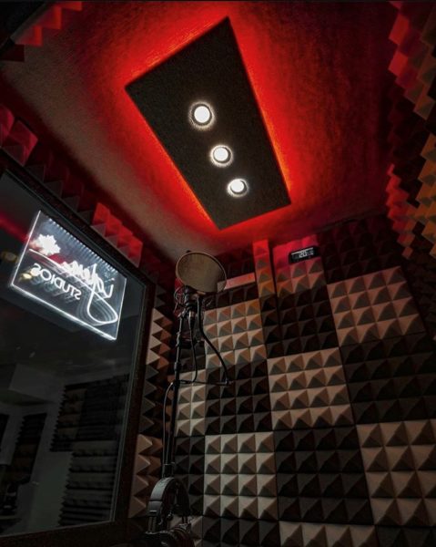 An image of red studio light and microphone inside of a WhisperRoom vocal booth
