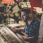 The Producer Dr. Ford sitting at a mixing console in a recording studio