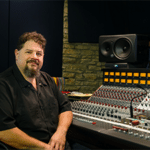 Steve Chadie sitting next to his mixing console