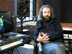 Producer Craig Alvin sitting next to his studio gear while having a conversation