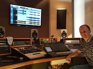 Andres Mayo sitting inside of his recording studio