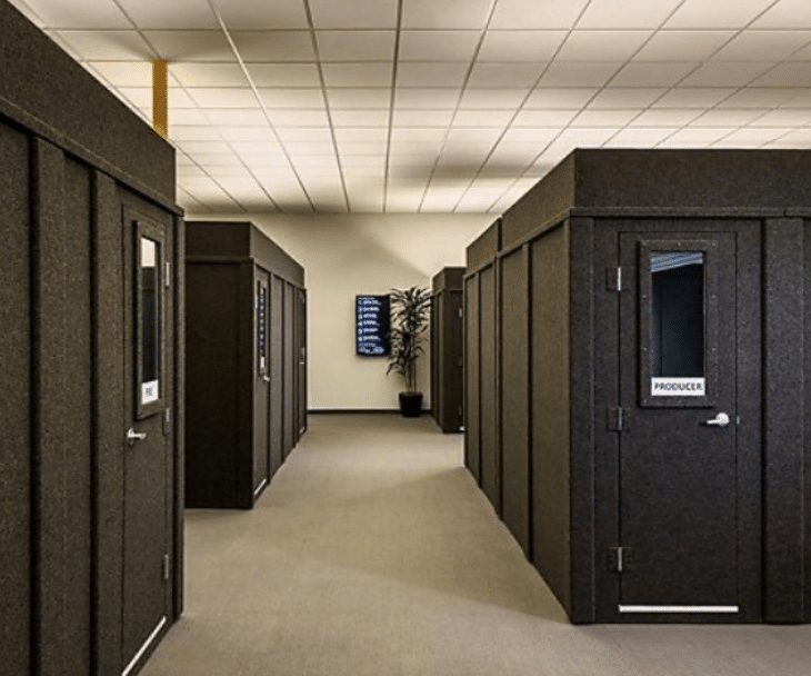 Several WhisperRoom privacy booths arranged in a large open floor office. These spacious privacy booths serve as individual offices for employees, providing a secluded and focused work environment within the bustling office space.