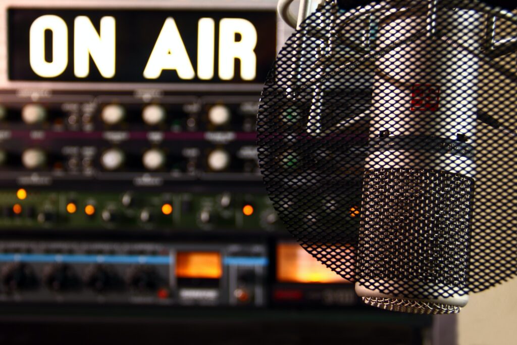 An "on-air" sign next to a microphone