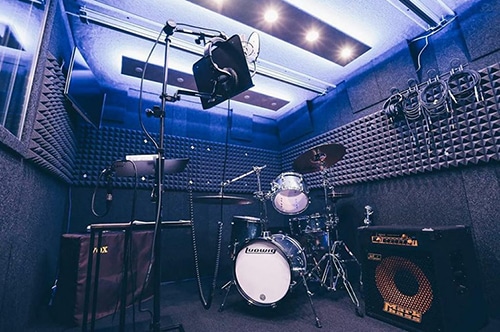 image of multiple instruments setup inside a whisperroom drum booth