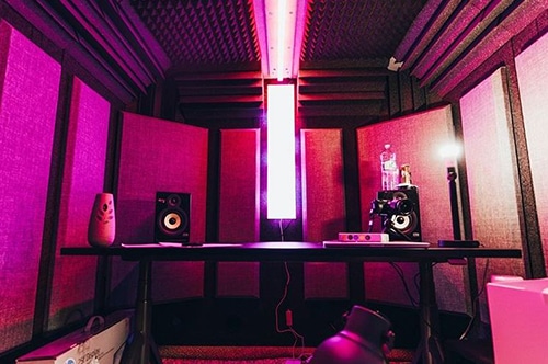 The interior of a WhisperRoom recording booth with acoustic sound panels on the wall.