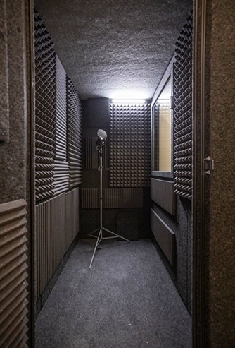 The interior of a WhisperRoom vocal booth with gray acoustic foam on all the walls.