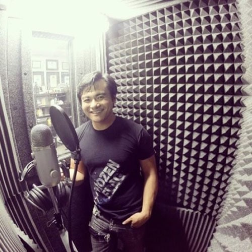 A man recording voice overs into a microphone in his WhisperRoom