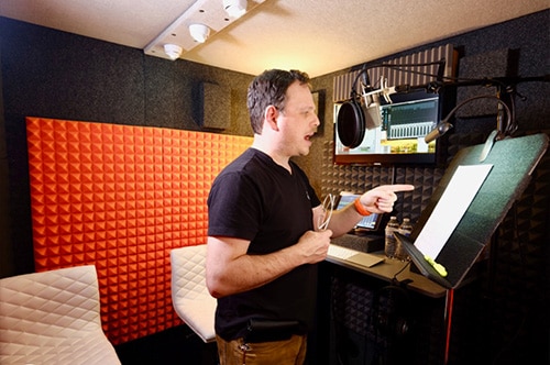 A man recording voice over inside his WhisperRoom