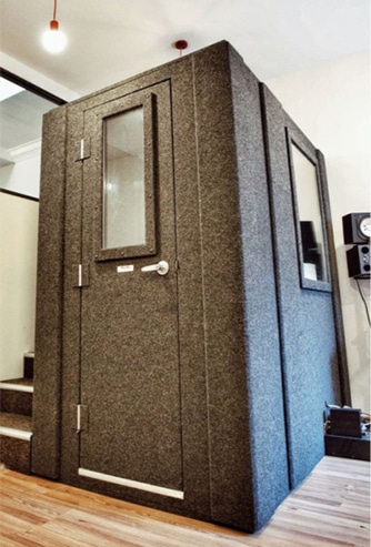 A WhisperRoom office phone booth inside of an open floor office.