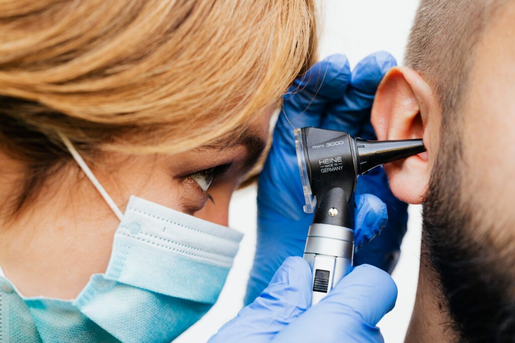 A female audiologist giving a man a hearing test