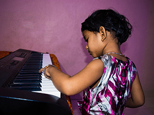 Young girl playing the keyboard