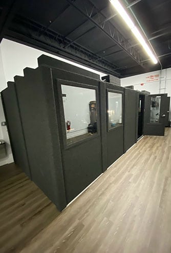 A WhisperRoom MDL 96192 S professional recording booth inside of a production studio.
