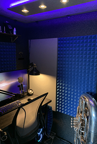 A recording setup and a tuba inside of a WhisperRoom sound isolation booth.