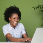 Smiling woman writing a podcast script on her computer