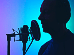 Man recording vocals into a condenser microphone