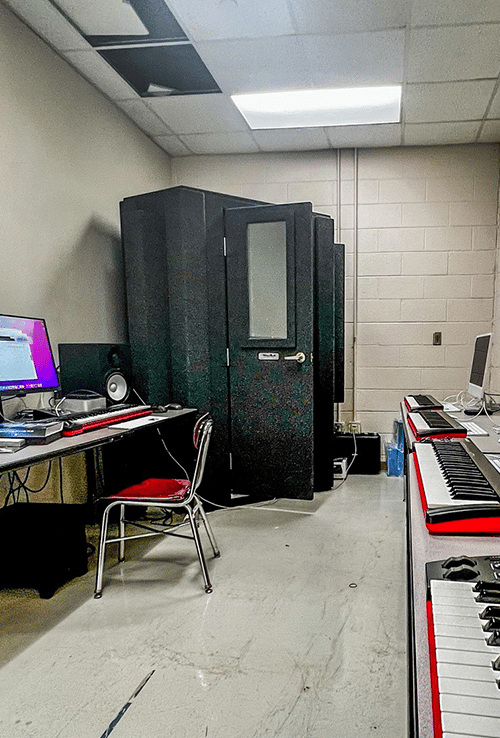 A WhisperRoom MDL 127 LP S shown inside of a high school's music lab.