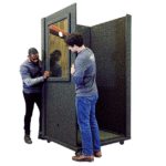 Two men assembling a WhisperRoom sound booth.