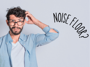 A perplexed man scratching his head with a speech bubble containing the words 'Noise Floor?' next to him. The man appears puzzled and unsure, reflecting the confusion and curiosity surrounding the concept of the noise floor.